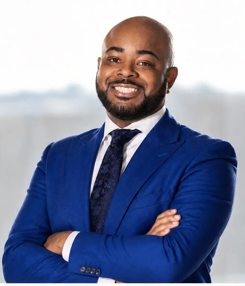 Rhett Butler, Founder and Chief Strategy Officer of Brand Power Institute, in a blue suit with arms crossed.